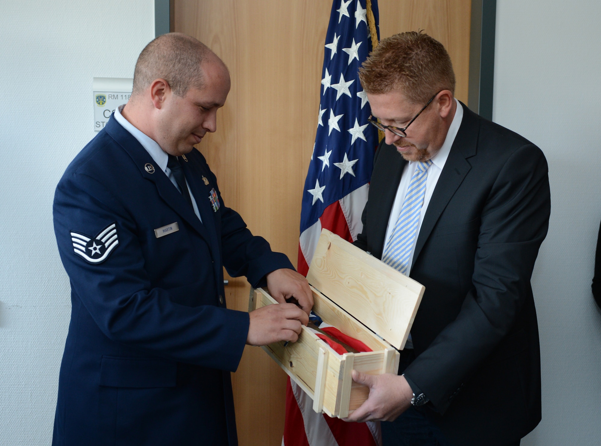 SPANGDAHLEM AIR BASE, Germany – Marco Haas presents a bayonet to U.S. Air Force Staff Sgt. Scott Martin, 606th Air Control Squadron radio frequencies transmissions systems operator from Chico, Calif., during a ceremony at the 606th ACS Oct. 4, 2012. The bayonet belonged to U.S. Army Pfc. Clyde Sparks, the grandfather of Martin’s wife, Jessica, who fought in Luxembourg during World War II. Martin accepted the bayonet on behalf of his wife’s family, who were unable to attend the ceremony. (U.S. Air Force photo by Staff Sgt. Nathanael Callon/Released)
