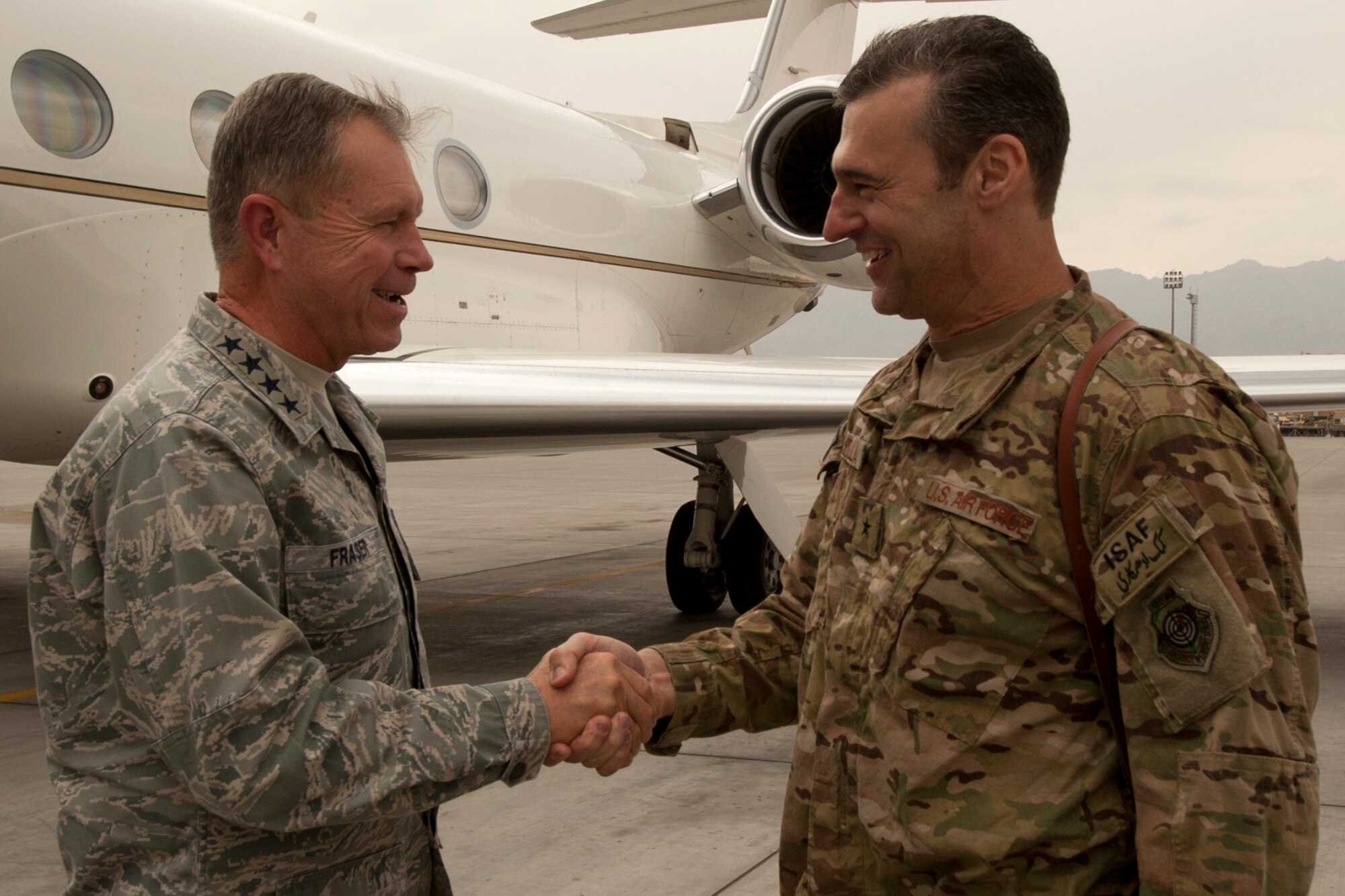 Gen. William Fraser III, U.S. Transportation Command commander (left), is greeted by Brig. Gen. Joseph Guastella, 455th Air Expeditionary Wing commander, as Fraser arrives at Bagram Airfield, Afghanistan, Oct. 19, 2012. The general met with leadership from the 455th Expeditionary Aerial Port Squadron and the U.S. Army 401st Army Field Support Brigade to discuss plans of returning U.S. military cargo and tactical vehicles to the U.S. (U.S. Air Force photo/SSgt Jeff Nevison)