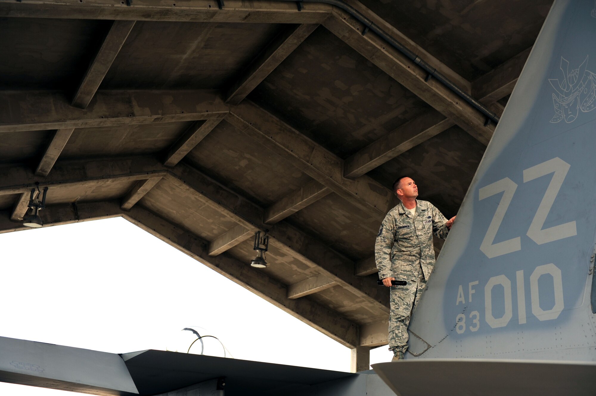 Master Sgt. Gabriel Frederick, a member of the Inspector General team, inspects the tail of a an F-15 Eagle fighter jet on Kadena Air Base, Japan, Oct. 22, 2012. The Pacific Air Forces readiness inspection tests how prepared the 18th Wing is for real-world contingency operations. (U.S. Air Force photo/Airman 1st Class Brooke P. Beers)