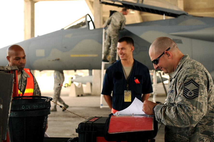 Senior Master Sgt. Antony Billing, a member of the Inspector General team, reviews F-15 Eagle fighter jet paperwork during a Pacific Air Forces readiness inspection on Kadena Air Base, Japan, Oct. 22, 2012.  The inspection tests how prepared Airmen are to handle real-world contingencies. (U.S. Air Force photo/Airman 1st Class Brooke P. Beers) 