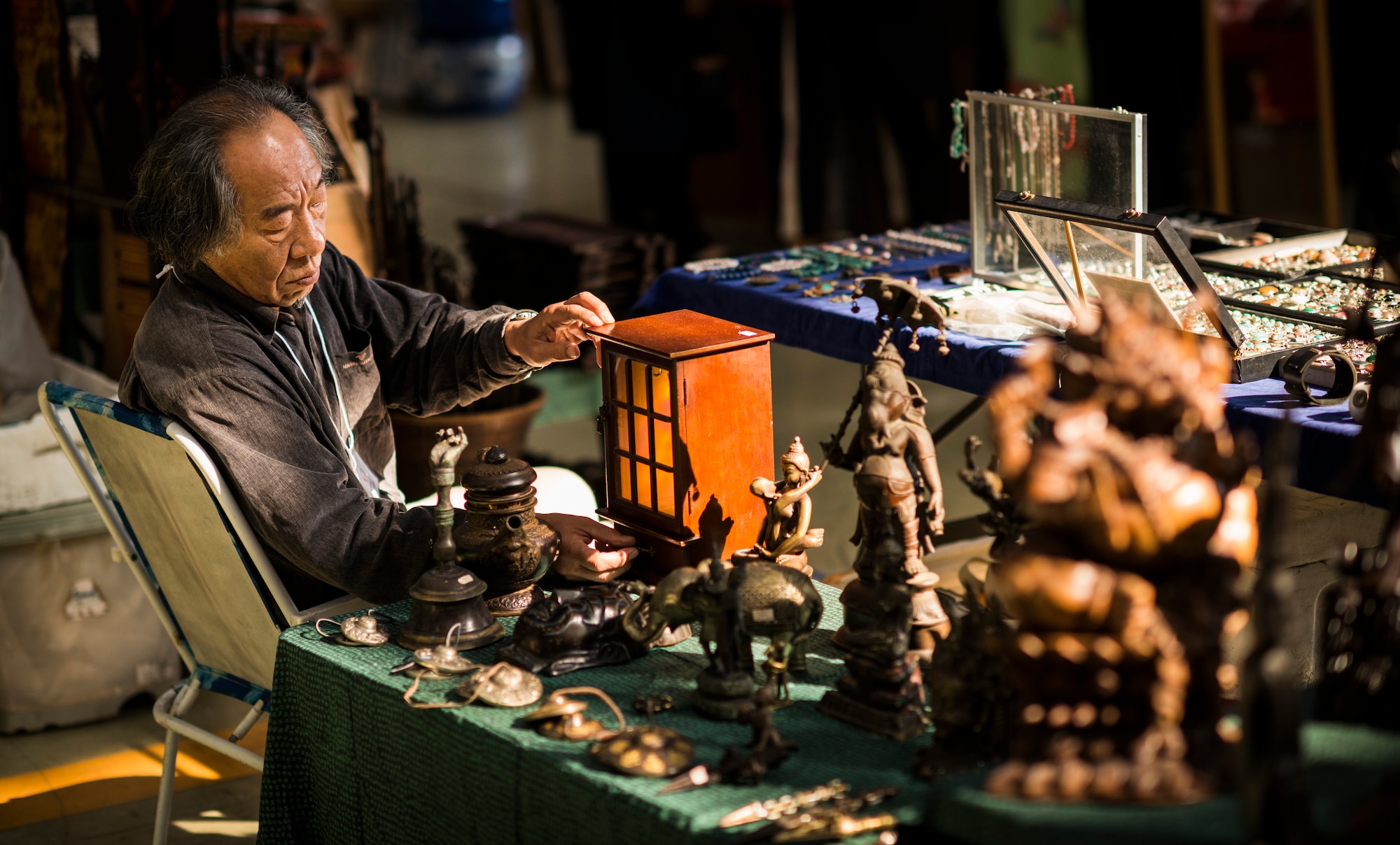 YOKOTA AIR BASE, Japan -- A vendor at the Yokota Officers' Spouses' Club Asian Bazaar adjusts his wares at Yokota Air Base, Japan, Oct. 20, 2012. (U.S. Air Force photo by Tech. Sgt. Samuel Morse)