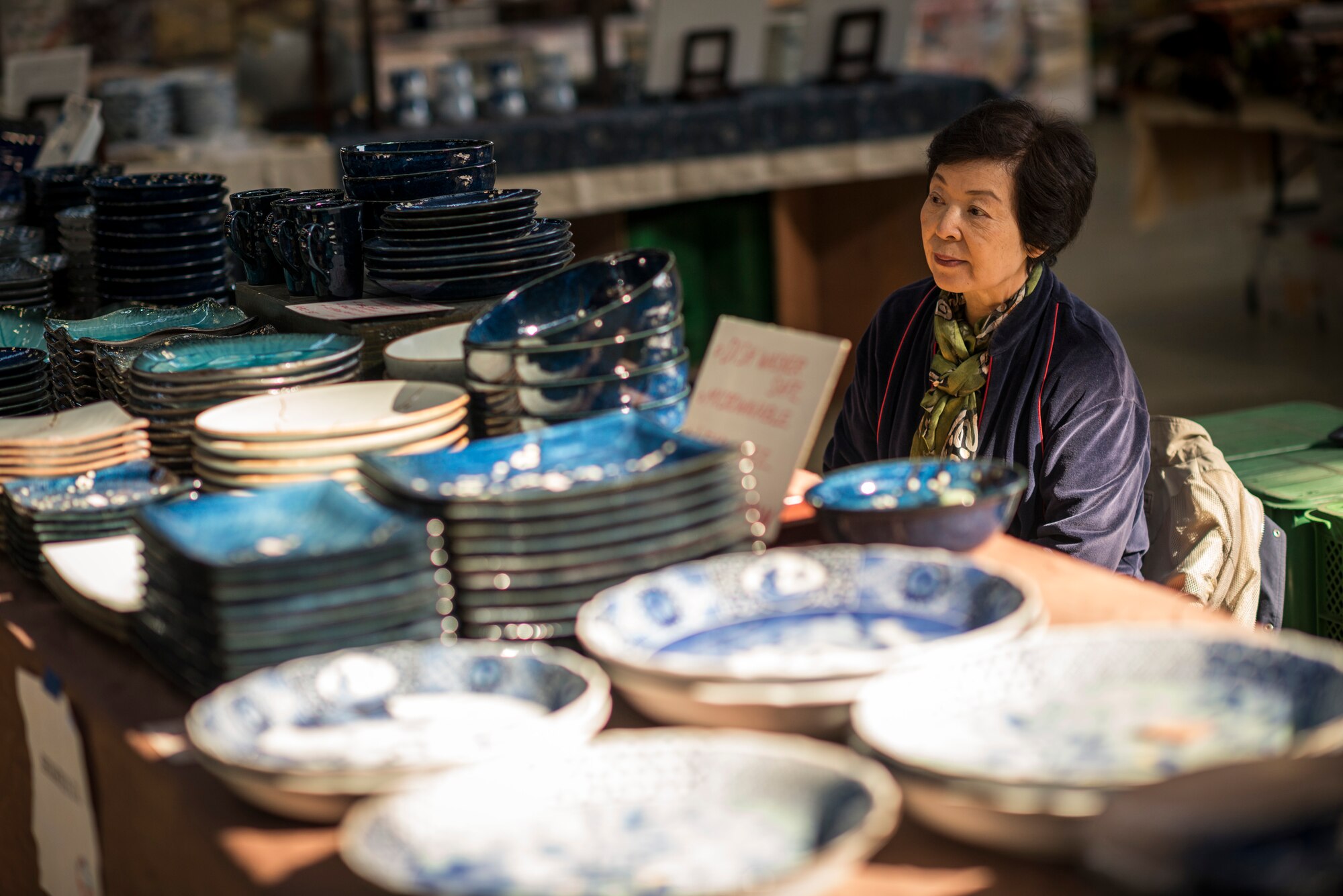 YOKOTA AIR BASE, Japan -- A vendor at the Yokota Officers' Spouses' Club Asian Bazaar waits for customers at Yokota Air Base, Japan, Oct. 20, 2012. (U.S. Air Force photo by Tech. Sgt. Samuel Morse)