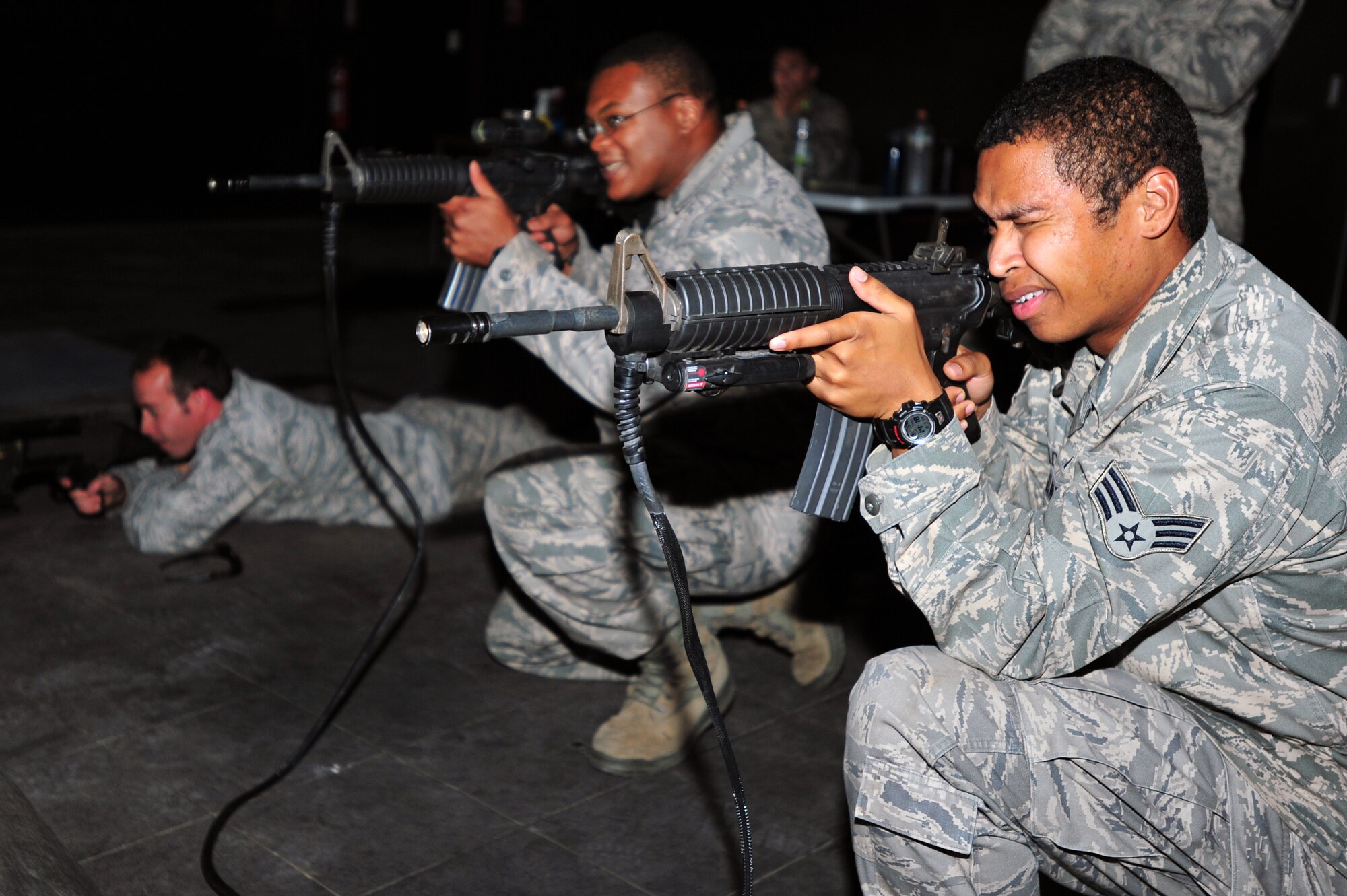 (Left to Right) Staff Sgt. Scott Stoffel, Tech. Sgt. Michael Dove, and Senior Airman Rafael Walden work through an attack scenario with the 51st Security Forces Squadron’s Engagement Skills Trainer 2000 at Osan Air Base, Republic of Korea, Oct. 4, 2012. The group went through several scenarios on a virtual trainer that allowed them to differentiate between hostile and non hostile forces. Stoffel, Dove and Walden are 51st Civil Engineer Squadron Explosive Ordinance Disposal technicians. (U.S. Air Force photo/Airman 1st Class Alexis Siekert) 
