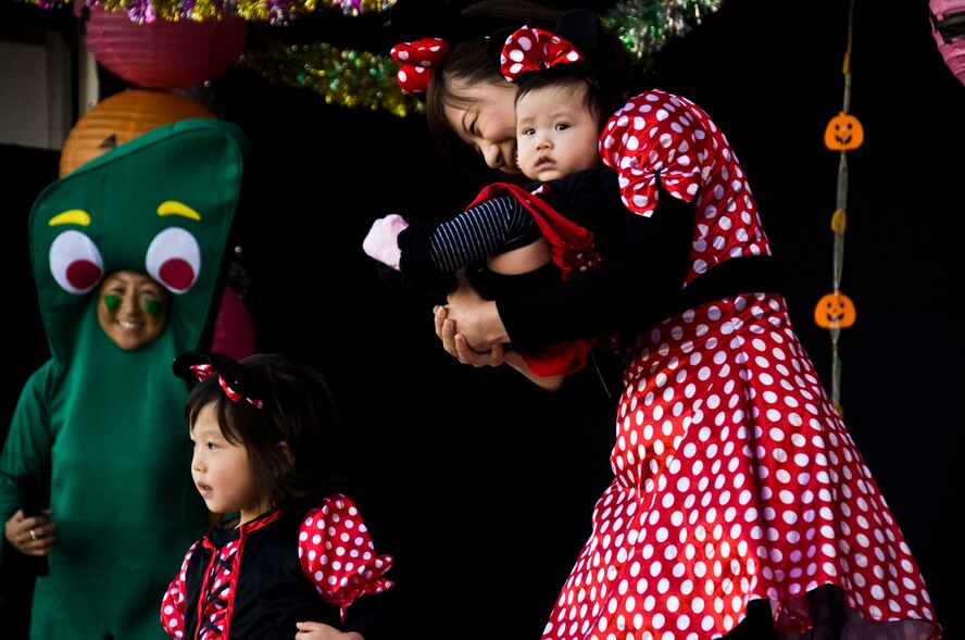 A Japanese woman dressed as Minnie Mouse and her two children show off their costumes during the Misawa Halloween Festival costume contest at Sky Plaza in Misawa City, Japan, Oct. 20, 2012. During the festival, families from the area spent the day together while being entertained with music, food and candy. (U.S. Air Force photo by Airman 1st Class Kenna Jackson)