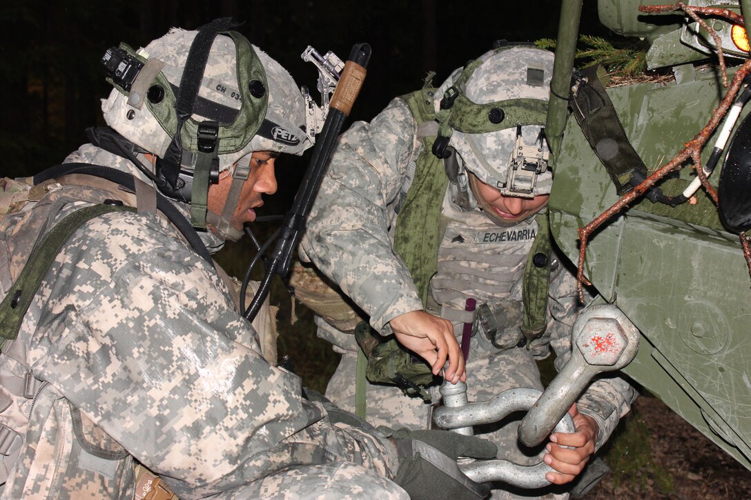 U.S. Army Sgts. William Hanna, left, and Angel Echevarria, right, connect a tow rope to a Stryker armored vehicle during Saber Junction 2012 in Bavaria, Germany, Oct. 15, 2012. Hanna and Echevarria are assigned to 1st Squadron, 2nd Cavalry Regiment. The exercise, led by the U.S. Army's 2nd Cavalry Regiment, uses live-fire, virtual and constructive training to prepare U.S. and international partner forces for a NATO deployment to Afghanistan.