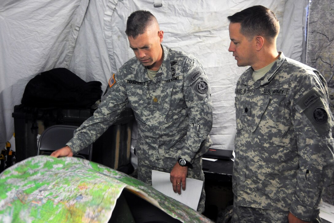 U.S. Army Lt. Col. Steven Keller, right, and Maj. William Dougherty, left, look at a map during Saber Junction 2012 on Joint Multinational Readiness Center in Hohenfels, Germany, Oct. 16, 2012. Keller and Dougherty are assigned to the 3rd Squadron, 2nd Cavalry Regiment.