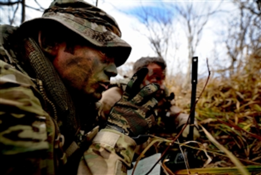 U.S. Air Force Tech. Sgt. Bobby Colliton and Staff Sgt. Dane Hatley conduct combat survival training near Osan Air Base, South Korea, during Exercise 2012 Pacific Thunder on Oct. 15, 2012.   Colliton is a survival evasion resistance and escape specialist from the 18th Operation Support Squadron at Kadena Air Base, Japan, and Hatley is a 33rd Rescue Squadron flight engineer.  