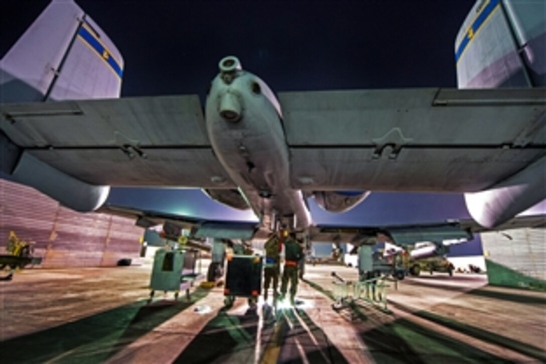 U.S. Air Force Staff Sgt. Marc Bapp, left, and U.S. Air Force Senior Airman James Weishaupt, right, perform routine maintenance on an A-10 Thunderbolt II, on Bagram Airfield, Afghanistan, Oct. 14, 2012. Bapp and Weishaupt are crew chiefs, assigned to the 455th Expeditionary Aircraft Maintenance Squadron. Bagram maintainers work around the clock to keep their Warthogs ready to fly close air support missions in support of coalition ground forces.