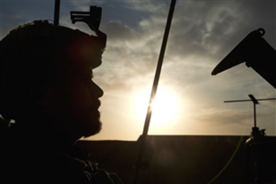 A coalition force member sits in his vehicle before conducting village stability operations in Khak-E-Safed, Farah province, Afghanistan, Oct. 20, 2012. Afghan National Security Forces have been taking the lead in security operations, with coalition forces as mentors.