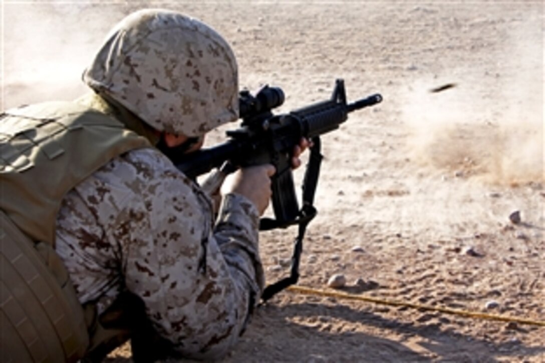U.S. Navy Capt. Theron C. Toole shoots an M4 carbine rifle on Camp Leatherneck in Afghanistan's Helmand province, Oct. 19, 2012. Toole, a wing surgeon, is assigned to 3rd Marine Aircraft Wing, Forward.
