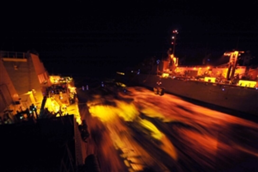 Crew members transfer stores from the Military Sealift Command fast combat support ship USNS Supply, right, to the guided-missile destroyer USS Jason Dunham during a replenishment at sea in the U.S. 5th Area of Responsibility, Oct. 13, 2012. The Jason Dunham is deployed to the U.S. 5th Fleet area of responsibility.