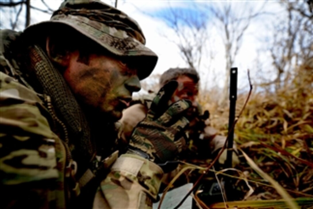 U.S. Air Force Tech. Sgt. Bobby Colliton and Staff Sgt. Dane Hatley conduct combat survival training near Osan Air Base, South Korea, during Exercise 2012 Pacific Thunder on Oct. 15, 2012.   Colliton is a survival evasion resistance and escape specialist from the 18th Operation Support Squadron at Kadena Air Base, Japan, and Hatley is a 33rd Rescue Squadron flight engineer.  