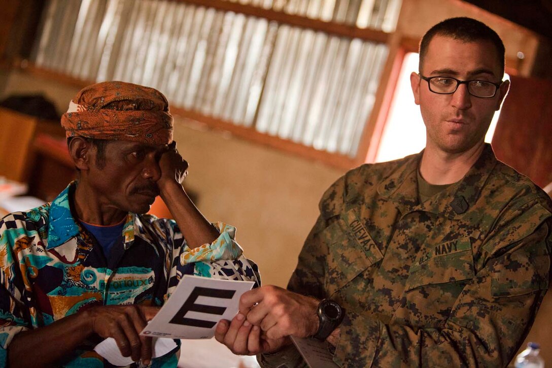U.S. Navy Hospital Corpsman 3rd Class William Cuevas, 15th Marine Expeditionary Unit (MEU), gives an eye exam to Timorese patients in Koelek, Timor-Leste, during Exercise Crocodilo 2012, Oct. 15, 2012. Exercise Crocodilo is a bilateral training event between U.S. and Timor-Leste forces.