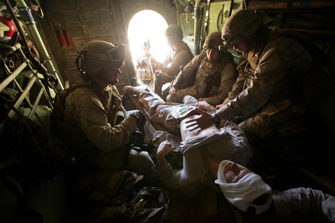 Marines with Company K, Battalion Landing Team 3rd Battalion, 2nd Marine Regiment, 26th Marine Expeditionary Unit, treat a simulated casualty in an Assault Amphibious Vehicle during a mechanized raid exercise aboard Marine Corps Base Camp Lejeune, N.C., Oct. 16. Marines with Special Operations Training Group, II Marine Expeditionary Force, trained the Marines of the 26th MEU in mechanized raid operations for two weeks in October.