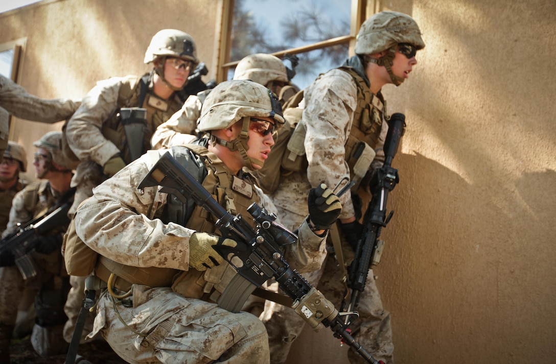 Corporal Joshua Treusch (second from right) a squad leader with Company K, Battalion Landing Team 3rd Battalion, 2nd Marine Regiment, 26th Marine Expeditionary Unit, determines where to direct his Marines during a mechanized raid exercise aboard Marine Corps Base Camp Lejeune, N.C., Oct. 16. Marines with Special Operations Training Group, II Marine Expeditionary Force, trained the Marines of the 26th MEU in mechanized raid operations for two weeks in October.