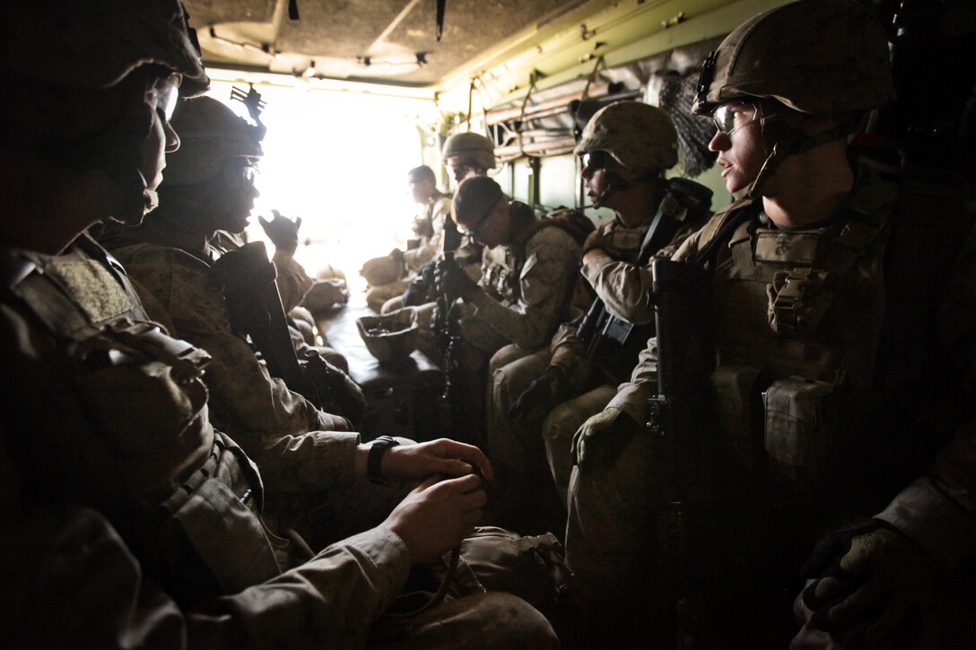 Marines with Company K, Battalion Landing Team 3rd Battalion, 2nd Marine Regiment, 26th Marine Expeditionary Unit, sit in an Assault Amphibious Vehicle before conducting a mechanized raid exercise aboard Marine Corps Base Camp Lejeune, N.C., Oct. 16. Marines with Special Operations Training Group, II Marine Expeditionary Force, trained the Marines of the 26th MEU in mechanized raid operations for two weeks in October.