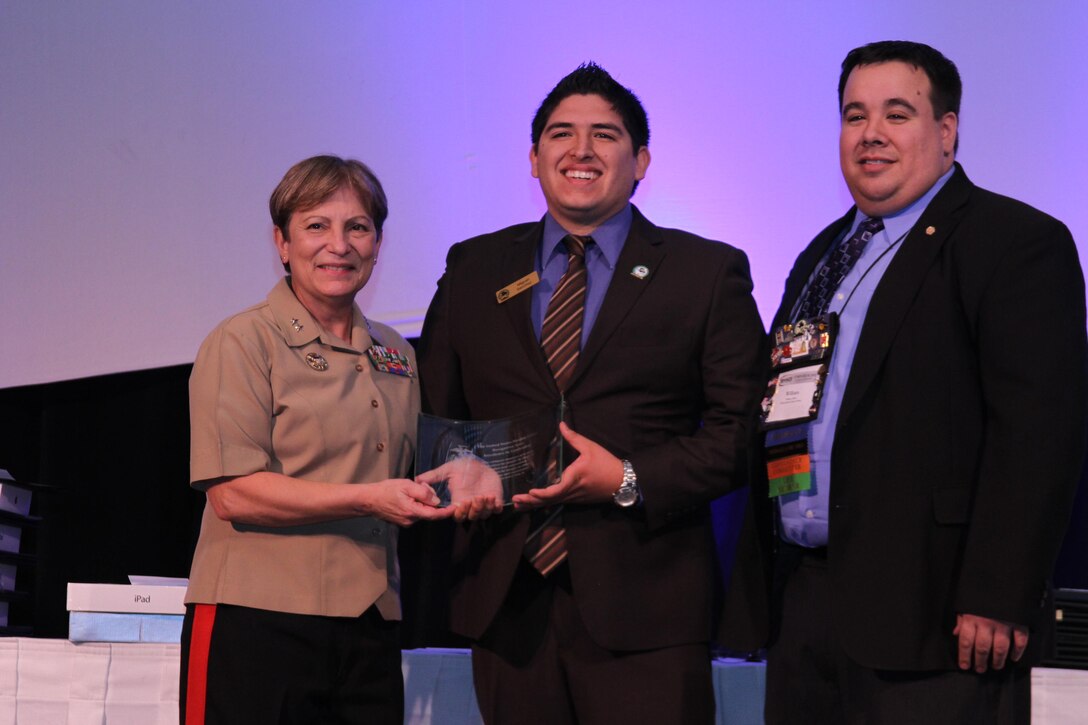 Major Gen. Angela Salinas, director, Manpower Management Division, presents a United States Marine Corps Excellence in Leadership Award to Miguez Sanchez, the University of California – Irvine MAES chapter president, during the 2012 MAES: Latinos in Science and Engineering Symposium at the Riviera Hotel & Casino, Oct. 13. Sanchez was recognized for his performance in the leadership role at the University of California – Irvine, which included organizing the trip to the MAES Symposium for his entire chapter.