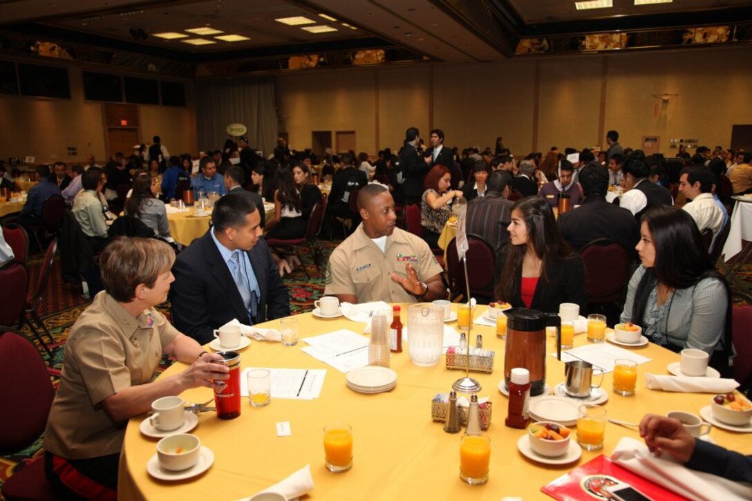 Major Gen. Angela Salinas, director, Manpower Management Division (left) and Master Sgt. Mark McArthur , diversity chief, Marine Corps Recruiting Command (center), speak to college students at the 2012 MAES: Latinos in Science and Engineering Symposium’s Speed Networking Breakfast at the Riviera Hotel & Casino, Oct. 12. During the Speed Networking Breakfast, Marines had the opportunity to speak directly with multiple groups of students.