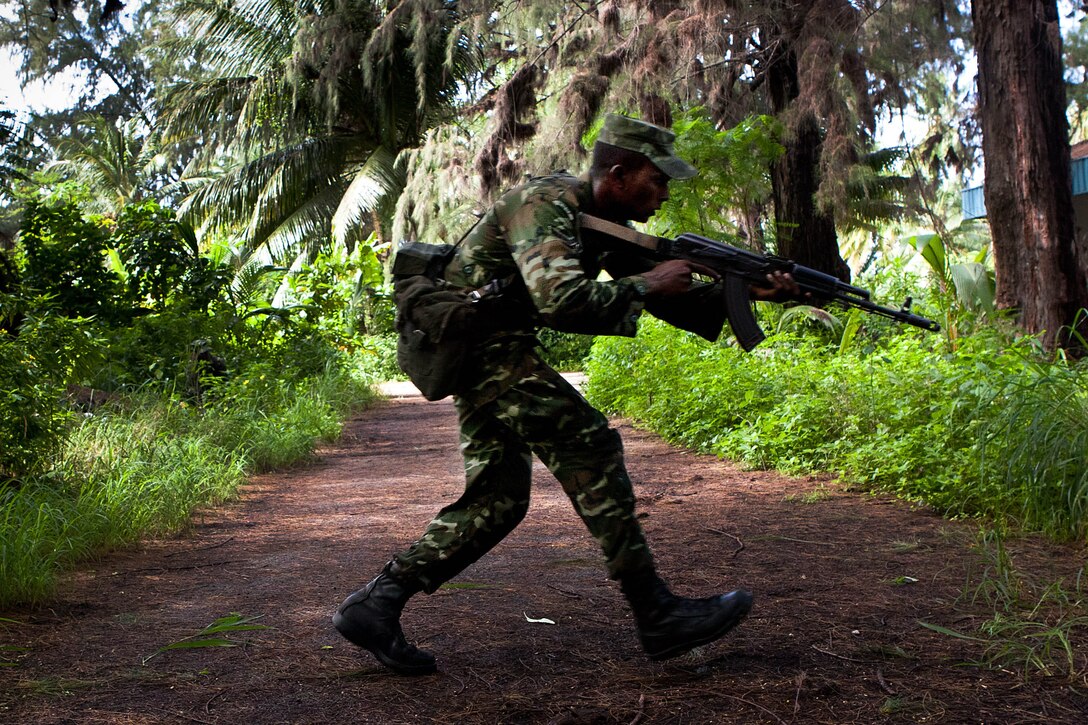 A Maldivian Marine moves forward to attack his objective during a raid here Oct. 16 as part of Exercise Coconut Grove 2012. The exercise is a bilateral training event conducted bi-annually between the U.S. Marine Corps and the Maldivian National Defense Force.