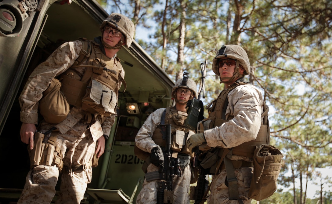 Corporal Joshua Treusch (right), a squad leader with Company K, Battalion Landing Team 3rd Battalion, 2nd Marine Regiment, 26th Marine Expeditionary Unit, watches as his Marines move to fighing positions during a mechanized raid exercise aboard Marine Corps Base Camp Lejeune, N.C., Oct. 16. Marines with Special Operations Training Group, II Marine Expeditionary Force, trained the Marines of the 26th MEU in mechanized raid operations for two weeks in October.