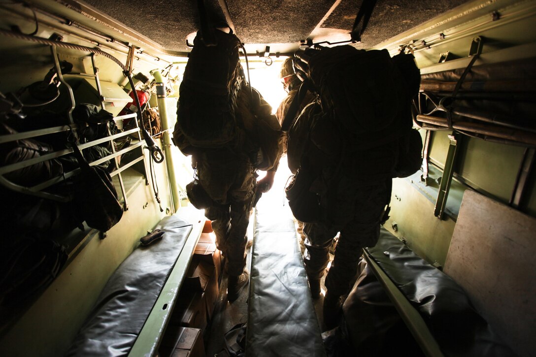 Marines with Company K, Battalion Landing Team 3rd Battalion, 2nd Marine Regiment, 26th Marine Expeditionary Unit, exit an Assault Amphibious Vehicle during a mechanized raid exercise aboard Marine Corps Base Camp Lejeune, N.C., Oct. 16. Marines with Special Operations Training Group, II Marine Expeditionary Force, trained the Marines of the 26th MEU in mechanized raid operations for two weeks in October.