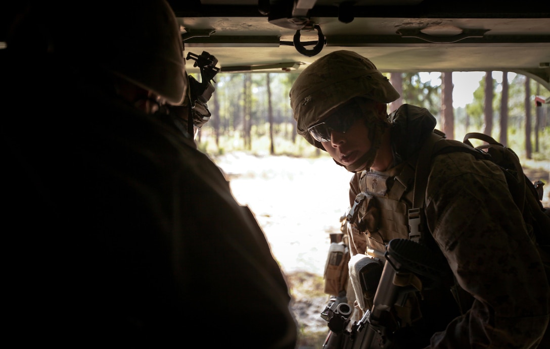 A Marine with Company K, Battalion Landing Team 3rd Battalion, 2nd Marine Regiment, 26th Marine Expeditionary Unit, prepares to exit an Assault Amphibious Vehicle during a mechanized raid exercise aboard Marine Corps Base Camp Lejeune, N.C., Oct. 16. Marines with Special Operations Training Group, II Marine Expeditionary Force, trained the Marines of the 26th MEU in mechanized raid operations for two weeks in October.