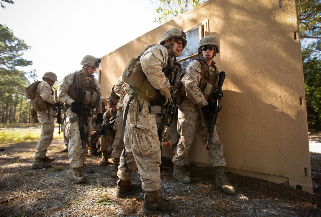 Corporal Joshua Treusch (second from right) a squad leader with Company K, Battalion Landing Team 3rd Battalion, 2nd Marine Regiment, 26th Marine Expeditionary Unit, determines where to direct his Marines during a mechanized raid exercise aboard Marine Corps Base Camp Lejeune, N.C., Oct. 16. Marines with Special Operations Training Group, II Marine Expeditionary Force, trained the Marines of the 26th MEU in mechanized raid operations for two weeks in October. 