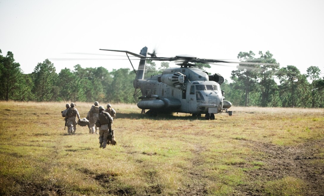 Marines with Company K, Battalion Landing Team 3rd Battalion, 2nd Marine Regiment, 26th Marine Expeditionary Unit, evacuate a simulated casualty to a CH-53 Super Stallion during a mechanized raid exercise aboard Marine Corps Base Camp Lejeune, N.C., Oct. 16. Marines with Special Operations Training Group, II Marine Expeditionary Force, trained the Marines of the 26th MEU in mechanized raid operations for two weeks in October.
