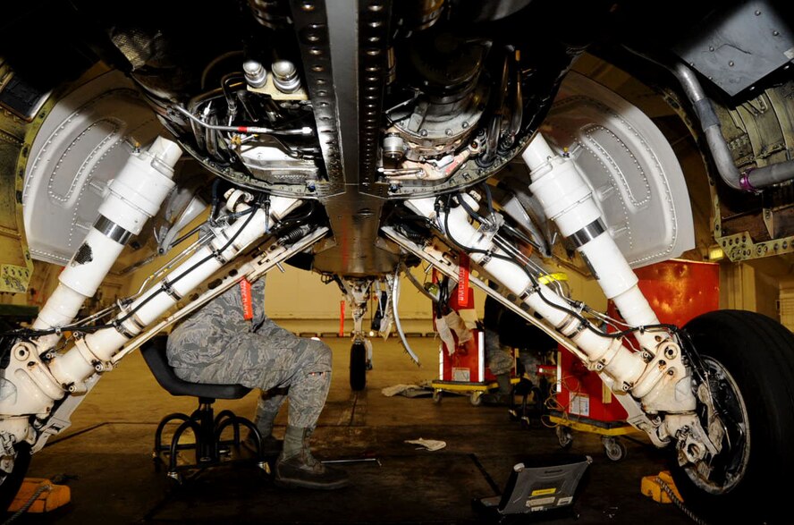 U.S. Air Force 14th Aircraft Maintenance Unit electrical and environmental specialists work on removing the damaged harness from the F-16 Fighting Falcon aircraft at Misawa Air Base, Japan, Oct. 12, 2012. The jet is scheduled for Onboard Oxygen Generation Systems upgrade in the fourth week of October. (U.S. Air Force photo by Airman 1st Class Kenna Jackson)