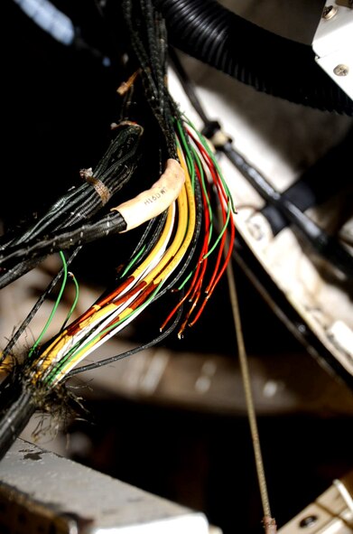 A U.S. Air Force F-16 Fighting Falcon aircraft’s open wires are exposed during the 14th Aircraft Maintenance electrical and environmental team’s harness removal operation at Misawa Air Base, Japan, Oct. 11, 2012. An open wire is a single wire that is split in two. (U.S. Air Force photo/Airman 1st Class Kenna Jackson) 
