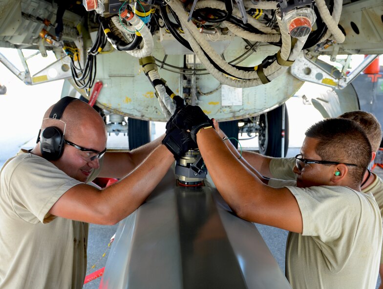ANDERSEN AIR FORCE BASE, Guam—Senior Airman Daniel Babis, (left), and Airman 1st Class Anthony Rodriguez, 36th Expeditionary Aircraft Maintenance Squadron weapons load technicians, install an umbilical connector into a training AGM-86C Conventional Air-Launched Cruise Missile during a B-52 Stratofortress load demonstration here, Oct. 17. The Airmen are deployed from the 96th Expeditionary Aircraft Maintenance Unit, Barksdale Air Force Base, La.  (U.S. Air Force photo by Senior Airman Benjamin Wiseman/Released)