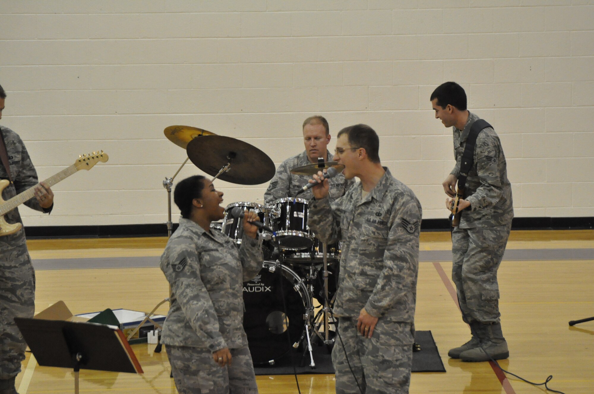 In support of Red Ribbon Week, the USAF Band of the Pacific-Top Cover performs for students in the Anchorage, Palmer, and Wasilla areas. The concerts feature many current musical favorites along with a powerful message to say "NO" to drugs and live a healthy lifestyle.  Pictured here, SSgt Natalie Madison-Rascoe and SSgt Clint Whitney share vocals during a recent concert.