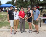 Brig. Gen. Theresa Carter, Joint Base San Antonio and 502nd Air Base Wing commander, (center) presents the gold medal and Coed Xtreme & Overall Fastest Xtreme Award to the Max Effort team Oct. 20 at Joint Base San Antonio Recreation Park, Canyon Lake, Texas.  Pictured from left are: Merle Richard, Holly Richard, Tim Hanson and Dave Larrabee. Max Effort participated in the seventh annual Rambler 120 triathlon, which includes a 22-mile bike course, a 6-mile run, and a 2-mile rafting course. (U.S. Air Force photo by Dan J. Solis)