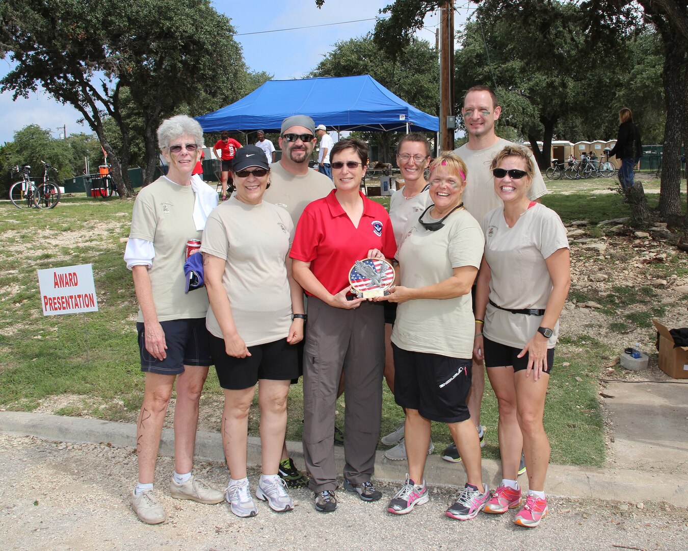 Brig. Gen. Theresa Carter, Joint Base San Antonio and 502nd Air Base Wing Commander, (center) presents the Most Mature Team award to the 50 Shades of Green team Oct. 20 at Joint Base San Antonio Recreation Park, Canyon Lake, Texas.  Pictured from left are: Pat Higgins, Sonia Rivera, John Meyer, Sue Wilson, Jo Grandelli, Larry Smedley and Tina McDaniel. The seventh annual Rambler 120 includes a 22-mile bike course, a 6-mile run and a 2-mile rafting course. (U.S. Air Force photo by Dan J. Solis) 