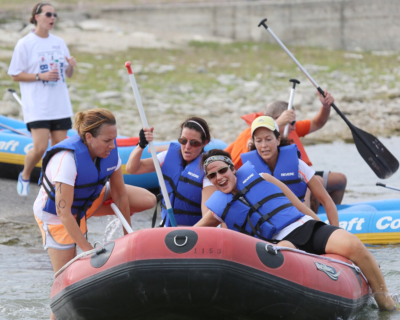 (From left to right)  Chrissy Jenkins, team captain, Rebecca Sinopoli, Danette Blair and Roberta Morrissey of the X-tremely Sweaty Housewives team board a raft for the 2-mile rafting portion of the Rambler 120 triathlon event held at Joint Base San Antonio Recreation Park, Canyon Lake, Texas, Oct. 20.  The team captured the Silver – All Female Xtreme category in the competition with a time of 2:57:40 (U.S. Air Force photo by Dan J. Solis)

