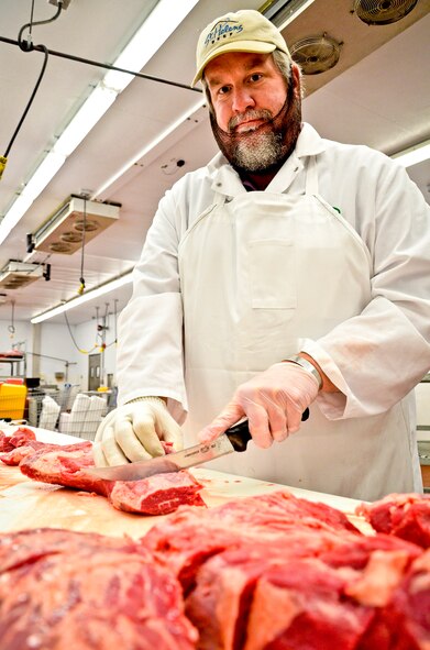 Ken Stephens works behind the commissary’s meat counter at Fairchild Air Force Base, Wash., Sept. 27, 2012. Stephens is a meat cutter and military spouse. He served in the Air Force as a medical supply specialist for nine years. (U.S. Air Force photo/Senior Airman Benjamin Stratton) 

