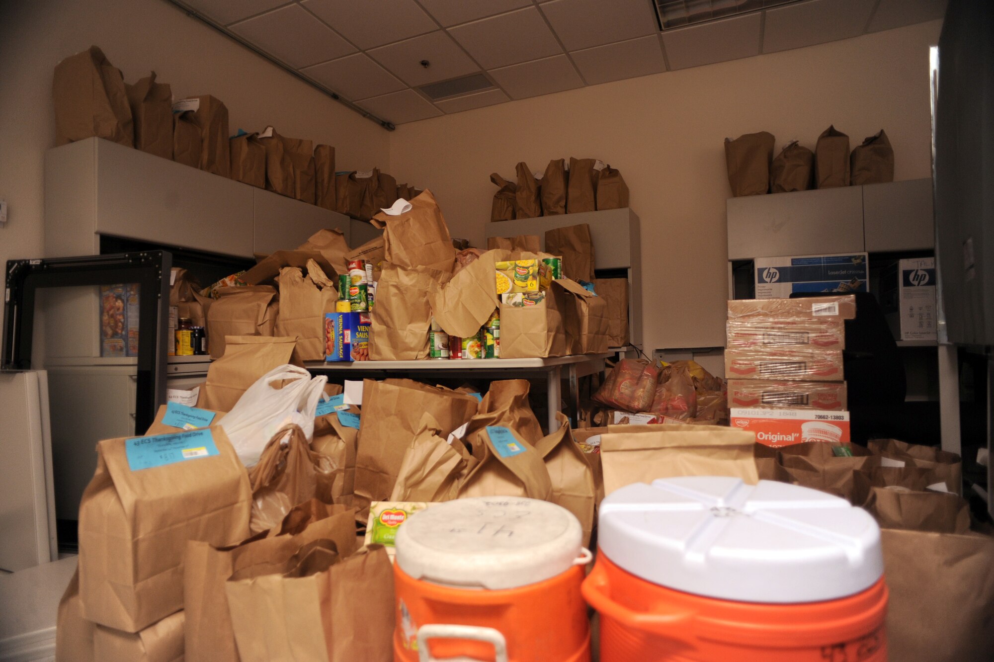 Piles of food sit in a room at the 43rd Electronic Combat Squadron on Davis-Monthan Air Force Base, Ariz., Oct. 23, 2012. The 43rd ECS aims to collect 5,000 pounds of canned goods. (U.S. Air Force photo by Airman 1st Class Christine Griffiths/Released) 