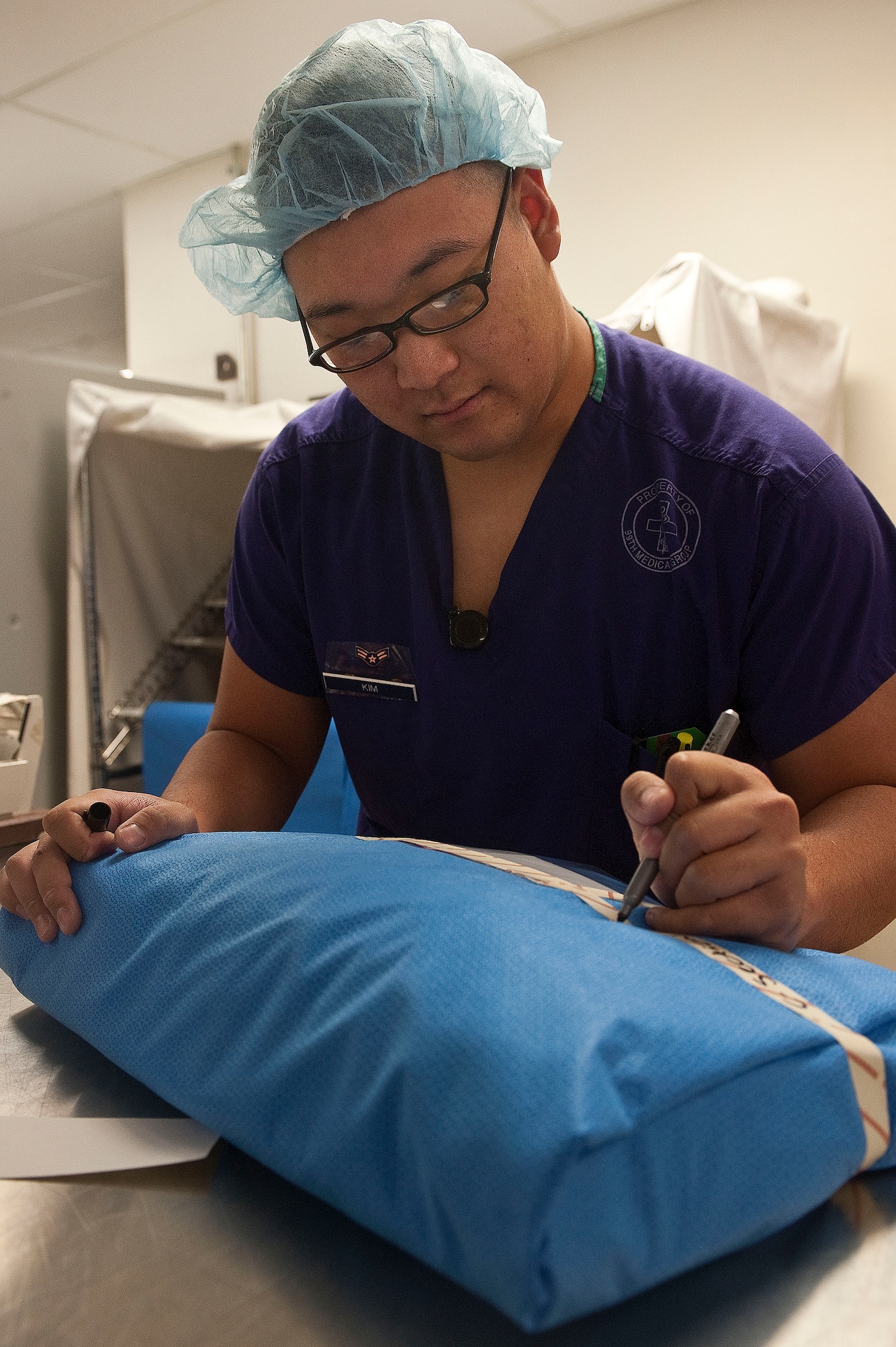 Airman 1st Class Nam Kim, 99th Surgical Operations Squadron surgical technician, wraps a surgical set of instruments to be processed and sterilized at the Mike O' Callaghan Federal Medical CenterOct. 22, 2012, at Nellis Air Force Base, Nev. The 99th MSGS has acquired a new colorectal surgery specialist and is expanding its services in the general,orthopedic, and plastic surgery departments. (U.S. Air Force photo by Staff Sgt. Christopher Hubenthal)