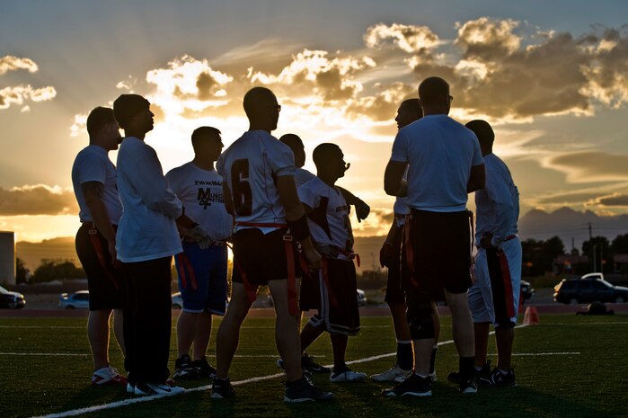 Members from the 820th RED HORSE Squadron get in a huddle before their game against the 757th Aircraft Maintenance Squadron in a flag football game Oct. 23, 2012, at Nellis Air Force Base, Nev. Flag football games are held every Monday through Thursday behind the Warrior Fitness Center. (U.S. Air Force photo by Senior Airman Daniel Hughes)