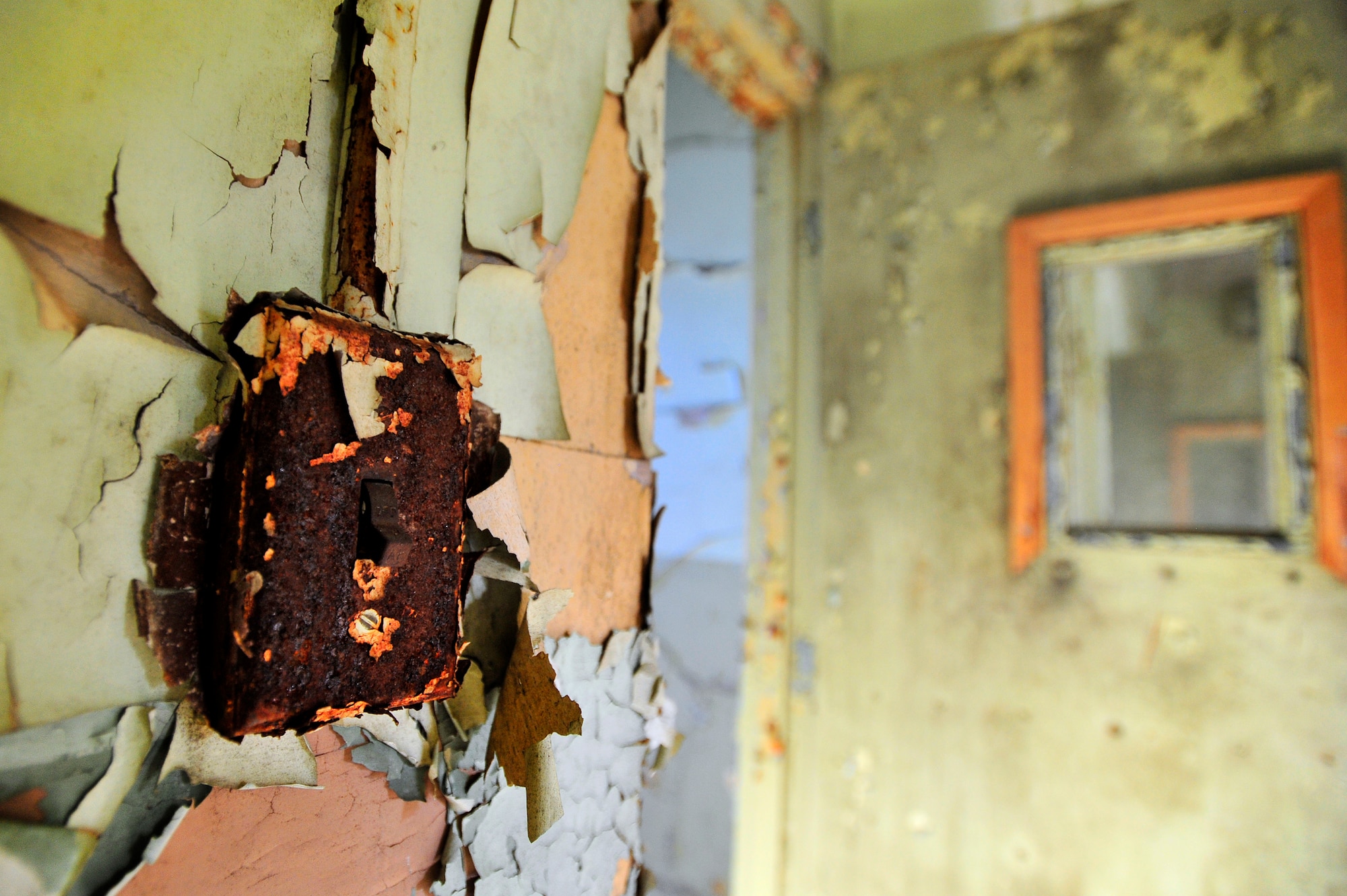 An old, weathered light switch is left in the off position after several years of use, Oct. 20, 2012, Columbia, S.C. The month of October marks National Energy Action Month, which encourages people to conserve energy. One way to aid in the conservation of energy is simply ensuring light switches are turned off when not in use. The switch in this image is located in an abandon insane asylum and no longer consumes energy as the power to the building has been turned off. (U.S. Air Force photo by Staff Sgt. Kenny Holston/Released)