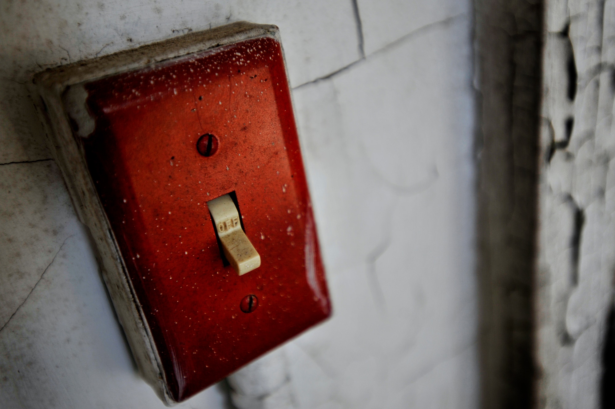 An old, weathered light switch is left in the off position after several years of use, Oct. 20, 2012, Columbia, S.C. The month of October marks National Energy Action Month, which encourages people to conserve energy. One way to aid in the conservation of energy is simply ensuring light switches are turned off when not in use. The switch in this image is located in an abandon insane asylum and no longer consumes energy as the power to the building has been turned off. (U.S. Air Force photo by Staff Sgt. Kenny Holston/Released)