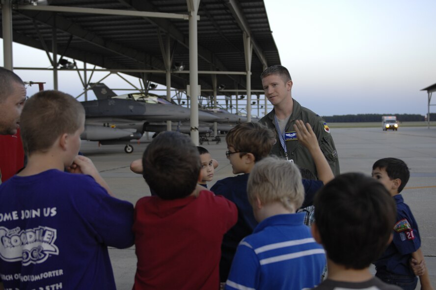 1st Lt. Taylor Tally, 55th Fighter Squadron F-16 Fighting Falcon wingman and scheduler, tells Cub Scout Pack 320 about being a pilot in an F-16 during a tour of the flight line at Shaw Air Force Base, S.C., Oct. 16, 2012. Cub Scouts are boys in between the ages seven and 10 years old or are in 1st through 5th grade. Boy between 11 to 17 years old can join Boy Scouts.(U.S. Air Force photo by Airman 1st Class Krystal M. Jeffers/Released)