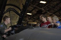 1st Lt. Taylor Tally, 55th Fighter Squadron F-16 Fighting Falcon wingman and scheduler, tells Cub Scout Pack 320 about being a pilot in an F-16 during a tour of the flight line at Shaw Air Force Base, S.C., Oct. 16, 2012. The Cub Scouts saw a F-16 with the jet engine taken out of it, an F-16 cockpit, how the gun bay was emptied, and a fully functional aircraft. (U.S. Air Force photo by Airman 1st Class Krystal M. Jeffers/Released))