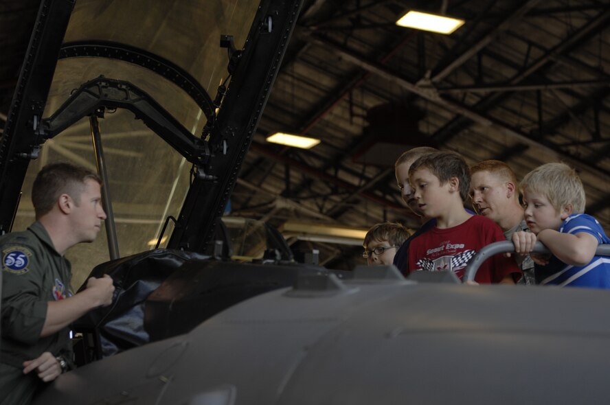 1st Lt. Taylor Tally, 55th Fighter Squadron F-16 Fighting Falcon wingman and scheduler, tells Cub Scout Pack 320 about being a pilot in an F-16 during a tour of the flight line at Shaw Air Force Base, S.C., Oct. 16, 2012. The Cub Scouts saw a F-16 with the jet engine taken out of it, an F-16 cockpit, how the gun bay was emptied, and a fully functional aircraft. (U.S. Air Force photo by Airman 1st Class Krystal M. Jeffers/Released))