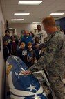 Tech. Sgt. Caleb Nicholas, currently assigned to 20th Maintenance Operation Squadron and the Cub Scout tigers den leader, shows Cub Scout Pack 320 the travel pod of Lt. Col. Christopher Claus, 55th Fighter Squadron commander, during a tour of the flight line at Shaw Air Force Base, S.C., Oct. 16, 2012. Travel pods are attached to F-16 Fighting Falcons and they hold maintenance equipment and the gear of the pilots for long trips.(U.S. Air Force photo by Airman 1st Class Krystal M. Jeffers/Released)