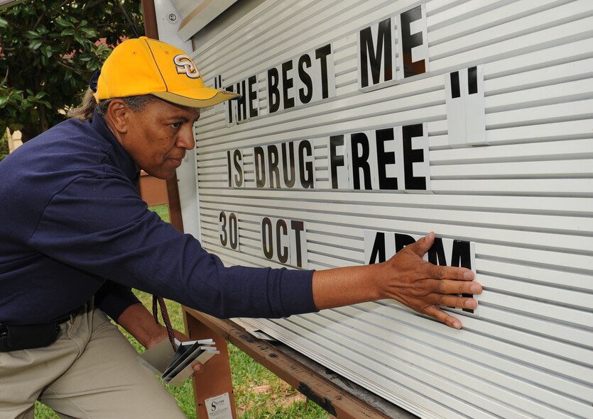Cora Davis, Barksdale Youth Center director of school age development programs, updates the Youth Center marquee for Red Ribbon Week on Barksdale Air Force Base, La., Oct. 23. Red Ribbon Week is celebrated annually Oct. 23-31 to inform the community of drug and alcohol abuse. On Oct. 30, the Barksdale Youth Center will hold an event where base children will pledge to stay drug free. (U.S. Air Force photo/Airman 1st Class Benjamin Gonsier)(RELEASED)
