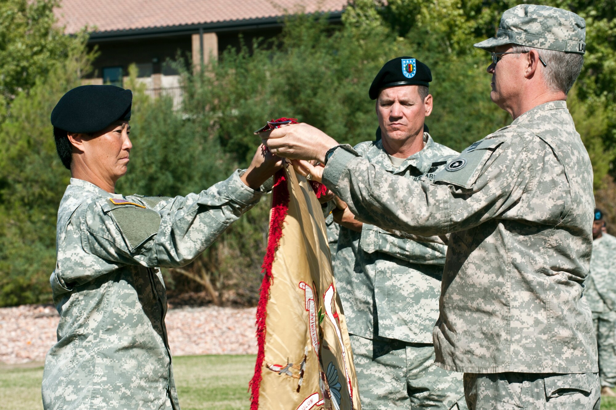 Lt. Col. Robyn Hamasaki, 63rd Brigade Support Battalion commander, and Col. Richard Lamb, 311th Sustainment Command commander, uncase the 63rd Brigade Support Battalion’s flag during the 63rd BSB activation ceremony Oct. 21, 2012, at Nellis Air Force Base, Nev. The 63rd BSB is a reserve unit that is located in southern Las Vegas. (U.S. Air Force photo by Airman 1st Class Jason Couillard)