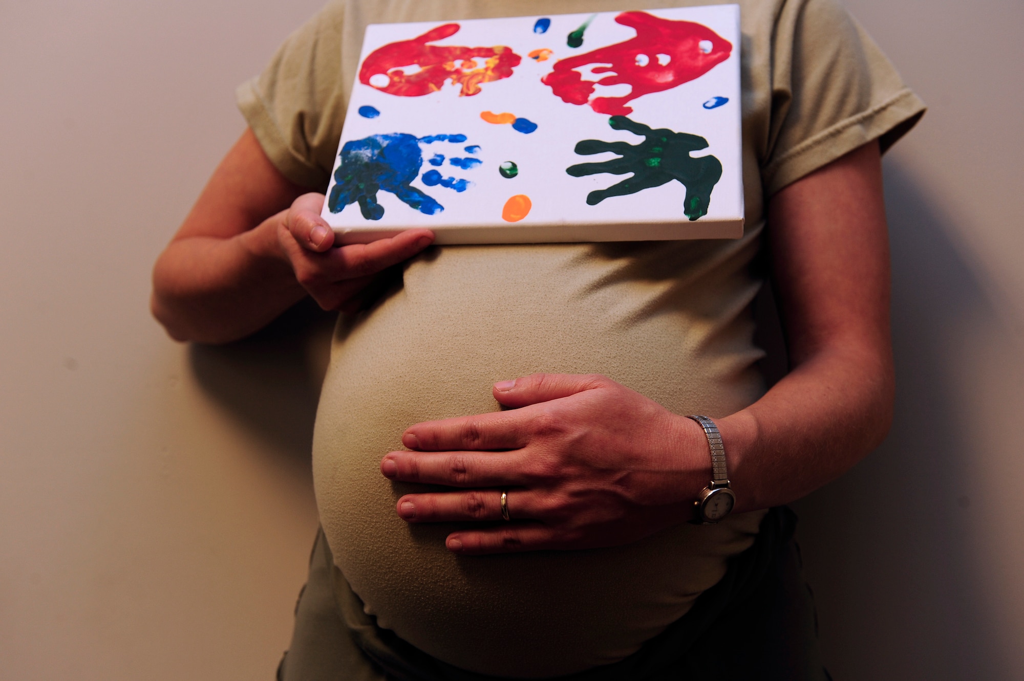 Staff Sgt. Shelby Bird, 20th Force Support Squadron Airman Leadership School instructor, poses with a work of art from her two children Tiernan and Riordan presented to her on Mother’s Day, while she also holds the life of her unborn child, Shaw Air Force Base, S.C., Oct. 22, 2012. “I think I’m a little biased, but my kids are the best and I love them so much.” (U.S. Air Force photo by Airman 1st Class Daniel Blackwell/Released)