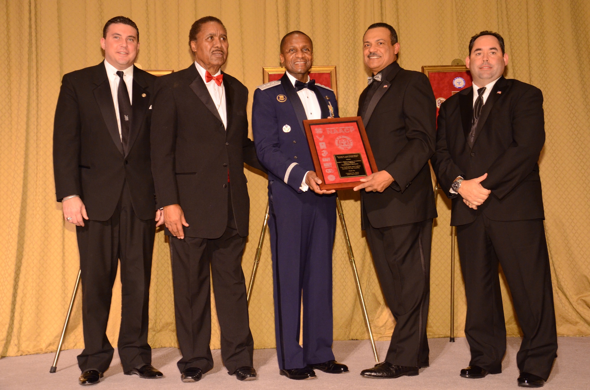 SCOTT AIR FORCE BASE, Ill. - Lt. Gen. Darren McDew, 18th Air Force commander, accepts an award honoring the service of military members here, Oct. 21, 2012 during the East St. Louis NAACP Freedom Fund Banquet at the Millennium hotel in St. Louis, Mo. From left to right, Michael McMillan, License Collector, City of St. Louis, Ill.; Rev. Johnny Scott, President, East St. Louis Branch of the NAACP; Richard Mark, Chairman, CEO and President, Ameren of Illinois; and Jeffrey K. Watson, General Manager, Casino Queen, East St. Louis, Ill.  
 (U.S. Air Force photo/Master Sgt. Kimberly Spinner)