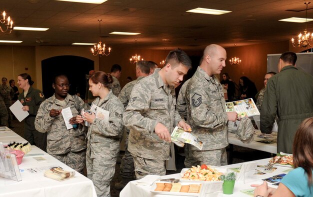 Senior Airman James Watkins, 28th Logistics Readiness squadron, and several Airmen new to the base gather information about various programs and activities offered on and off base during a Happy Landings event at the Dakota’s Club at Ellsworth Air Force Base, S.D., Oct. 16, 2012. Happy Landings is a monthly event where base facilities and local businesses set up booths to provide information about the local area to newly assigned Airmen and their families. (U.S. Air Force photo by Airman 1st Class Anania Tekurio/Released)